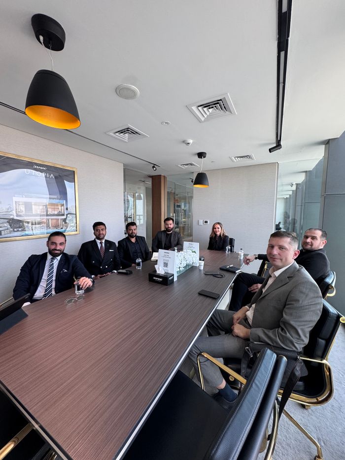 class-03 Business professionals in a formal meeting at a modern conference room.